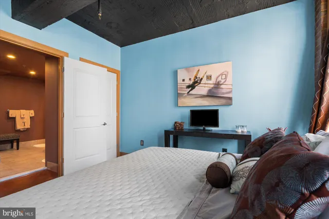 a bedroom with a bed and a flat screen tv