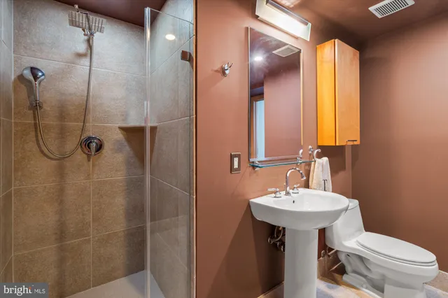 a bathroom with a sink toilet and shower