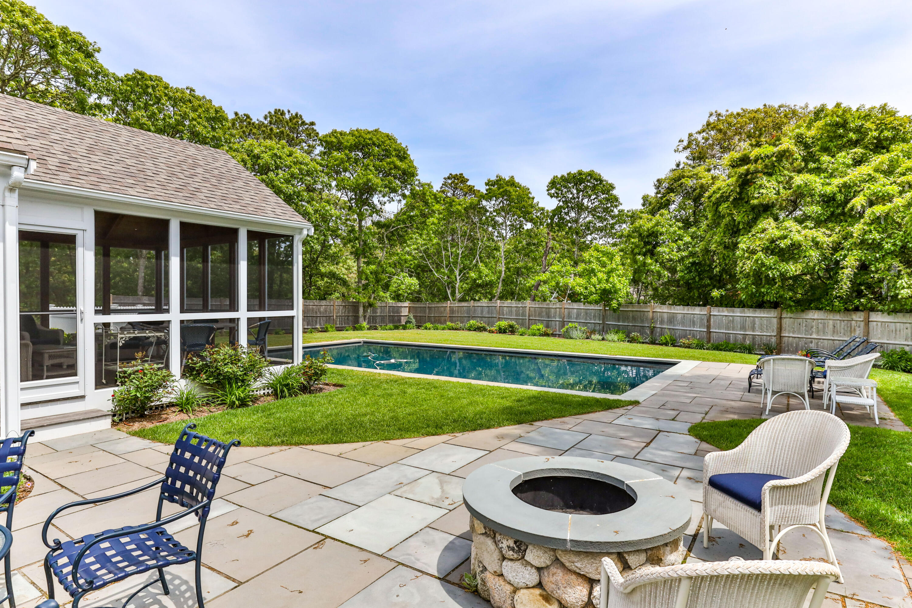 88 Round Cove Road Chatham, MA 02633 - Photo 24 of 58 a view of an chairs and table in the patio and a yard