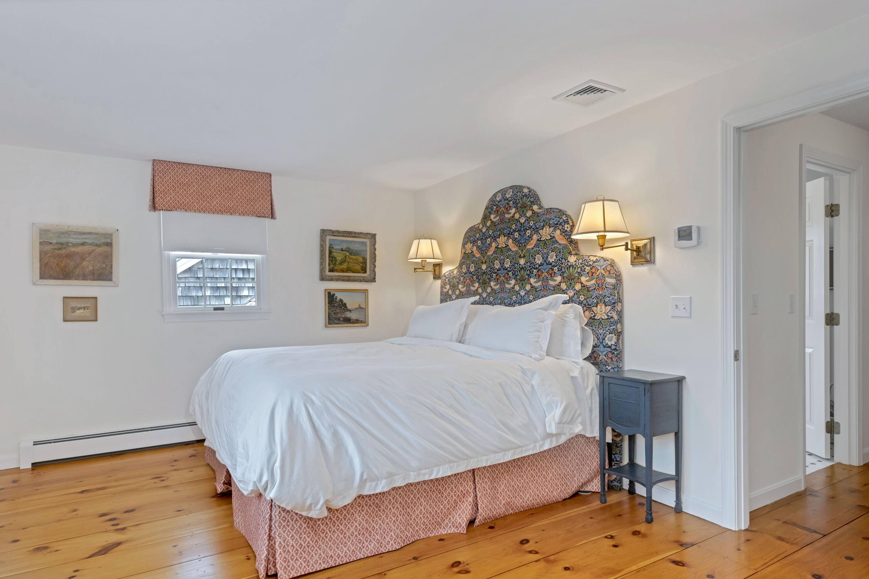 88 Round Cove Road Chatham, MA 02633 - Photo 40 of 58 a bedroom with a bed and a chandelier