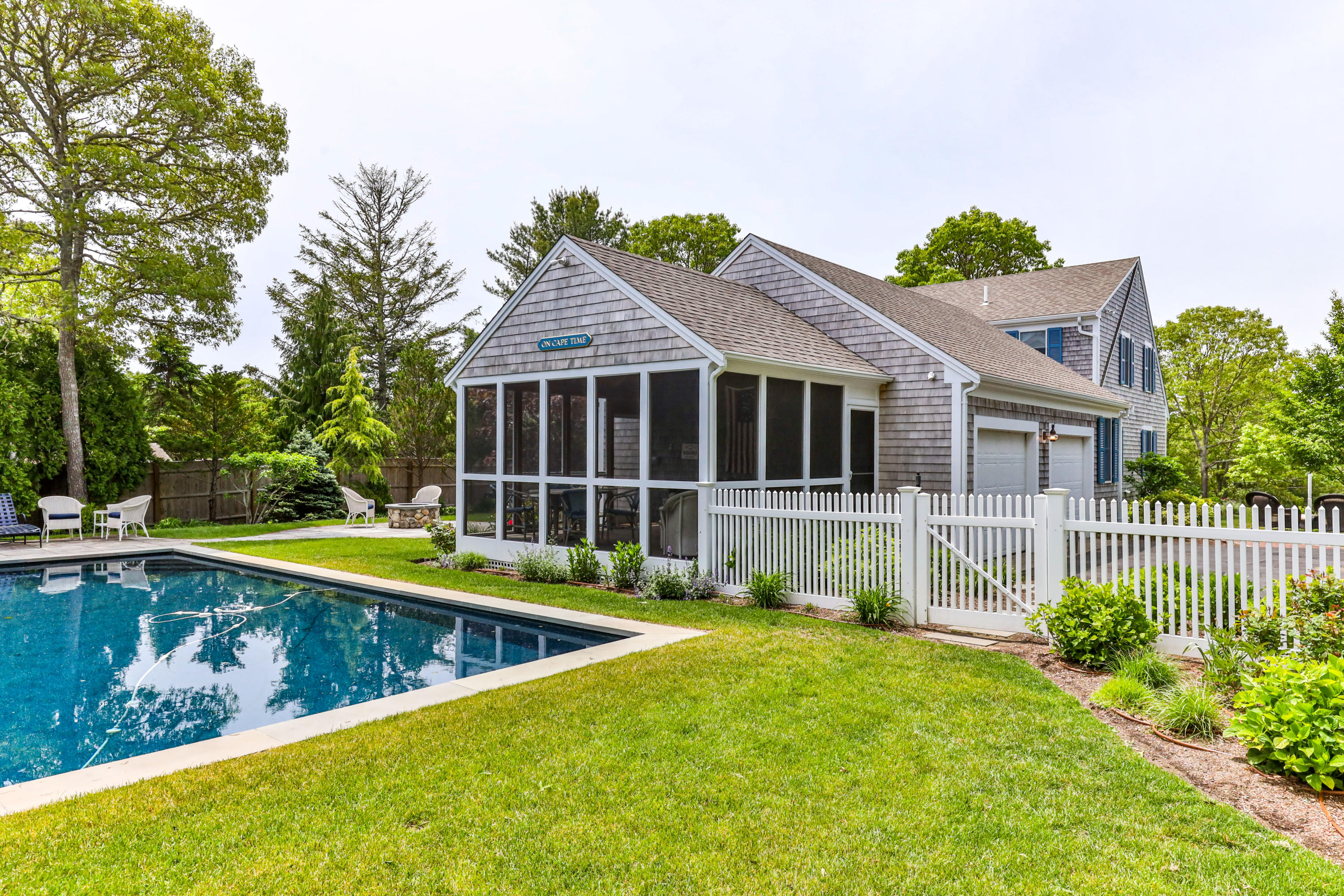 88 Round Cove Road Chatham, MA 02633 - Photo 50 of 58 a view of a house with pool and chairs