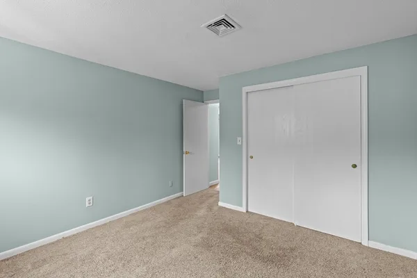 a view of an empty room and closet area