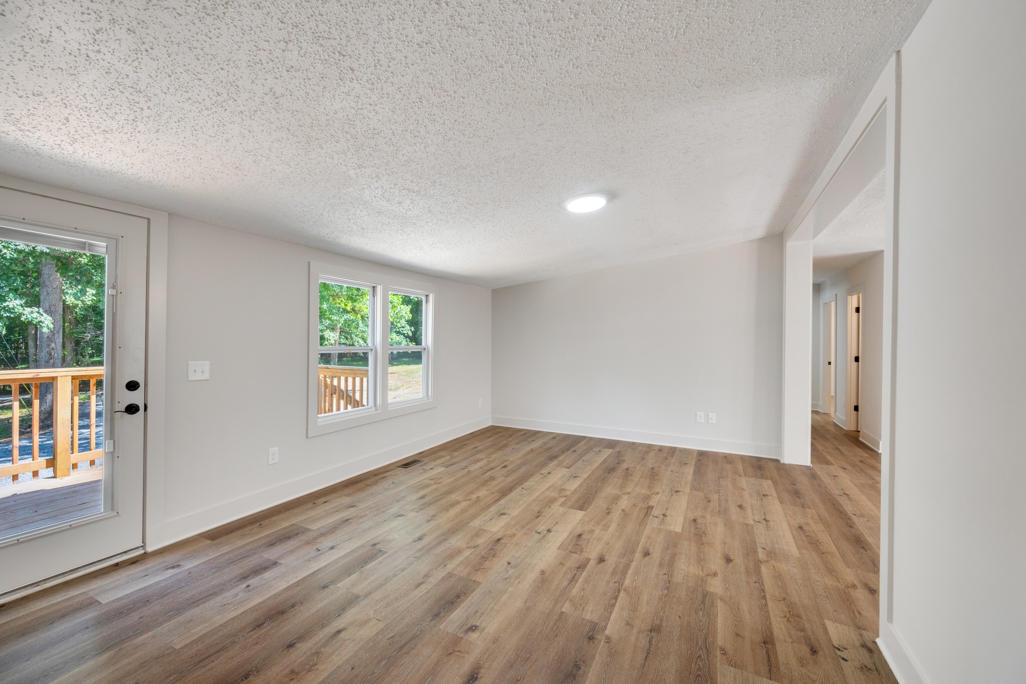 9064 New Chapel Road Springfield, TN 37172 - Photo 13 of 33 a view of an empty room with wooden floor and a window