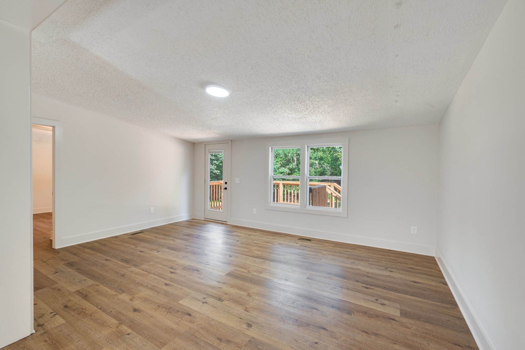 9064 New Chapel Road Springfield, TN 37172 - Photo 14 of 33 an empty room with wooden floor and windows
