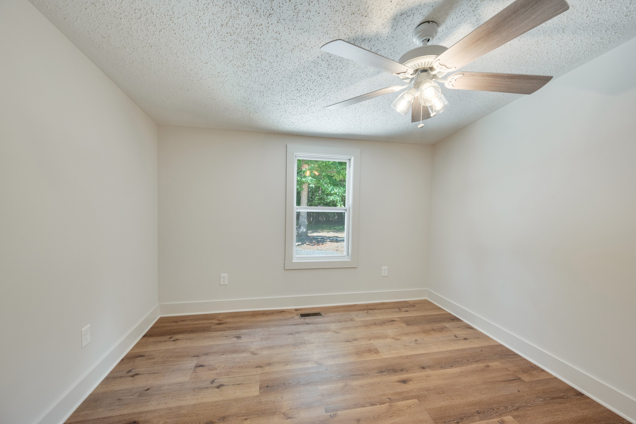 9064 New Chapel Road Springfield, TN 37172 - Photo 16 of 33 an empty room with wooden floor and windows