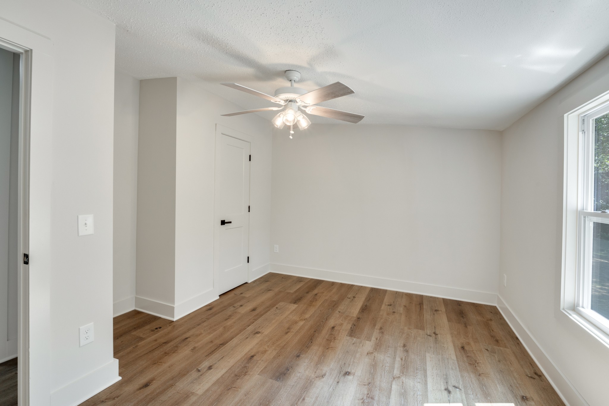 9064 New Chapel Road Springfield, TN 37172 - Photo 18 of 33 a view of a room with wooden floor and a ceiling fan