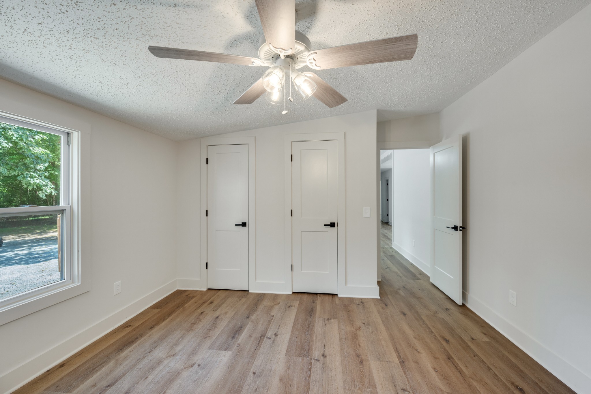 9064 New Chapel Road Springfield, TN 37172 - Photo 20 of 33 a view of an empty room with wooden floor and a window