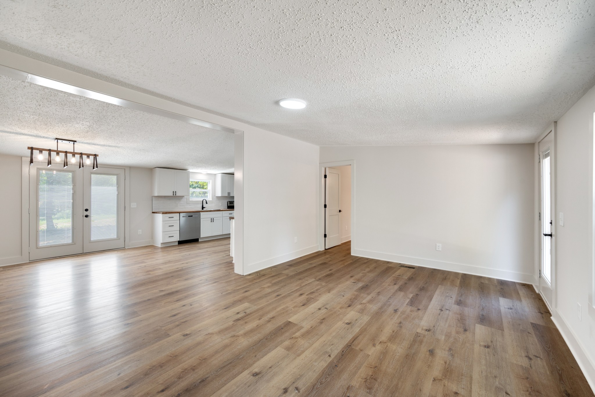 9064 New Chapel Road Springfield, TN 37172 - Photo 3 of 33 a view of empty room with wooden floor and windows