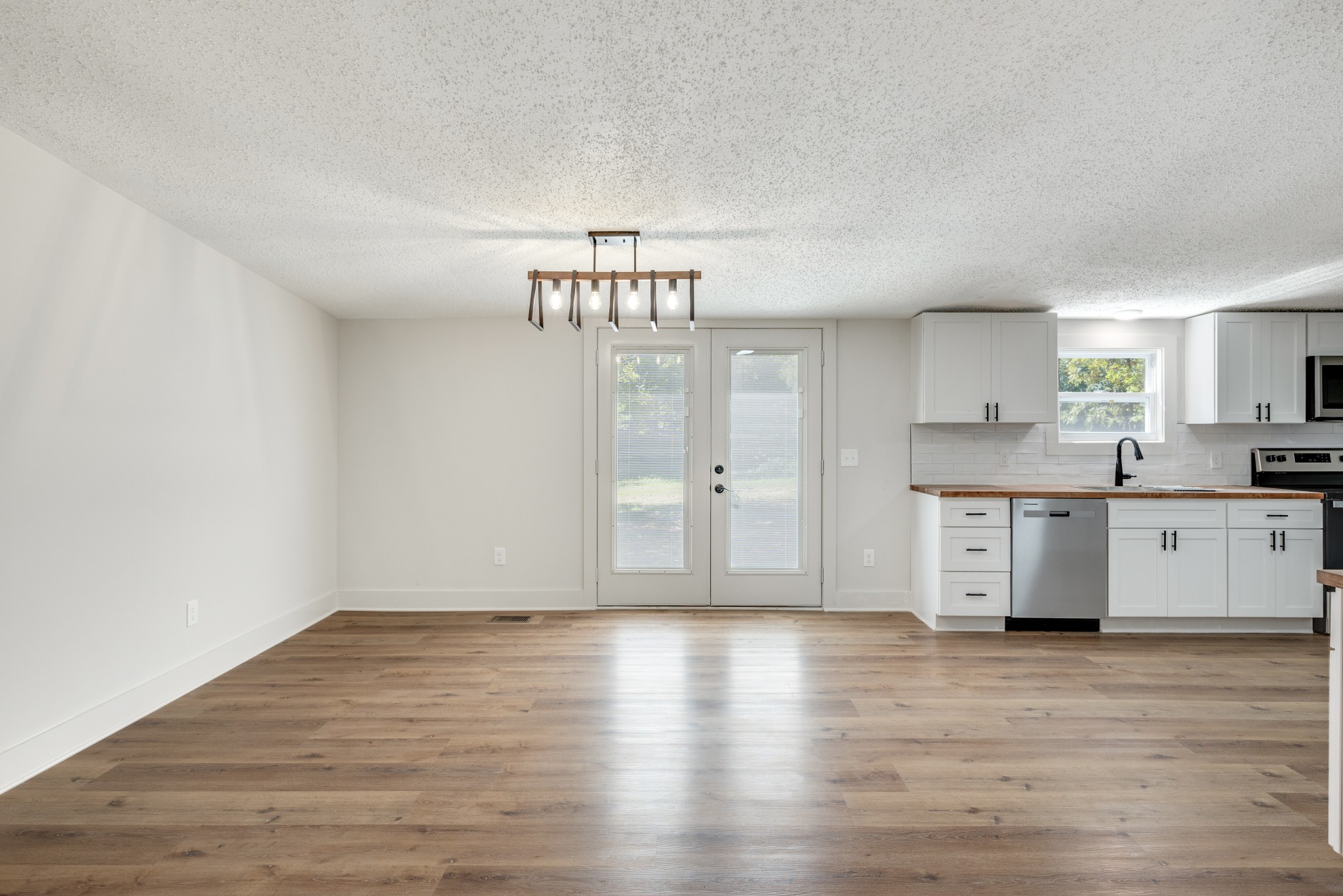 9064 New Chapel Road Springfield, TN 37172 - Photo 4 of 33 a view of a kitchen with wooden floor and a sink