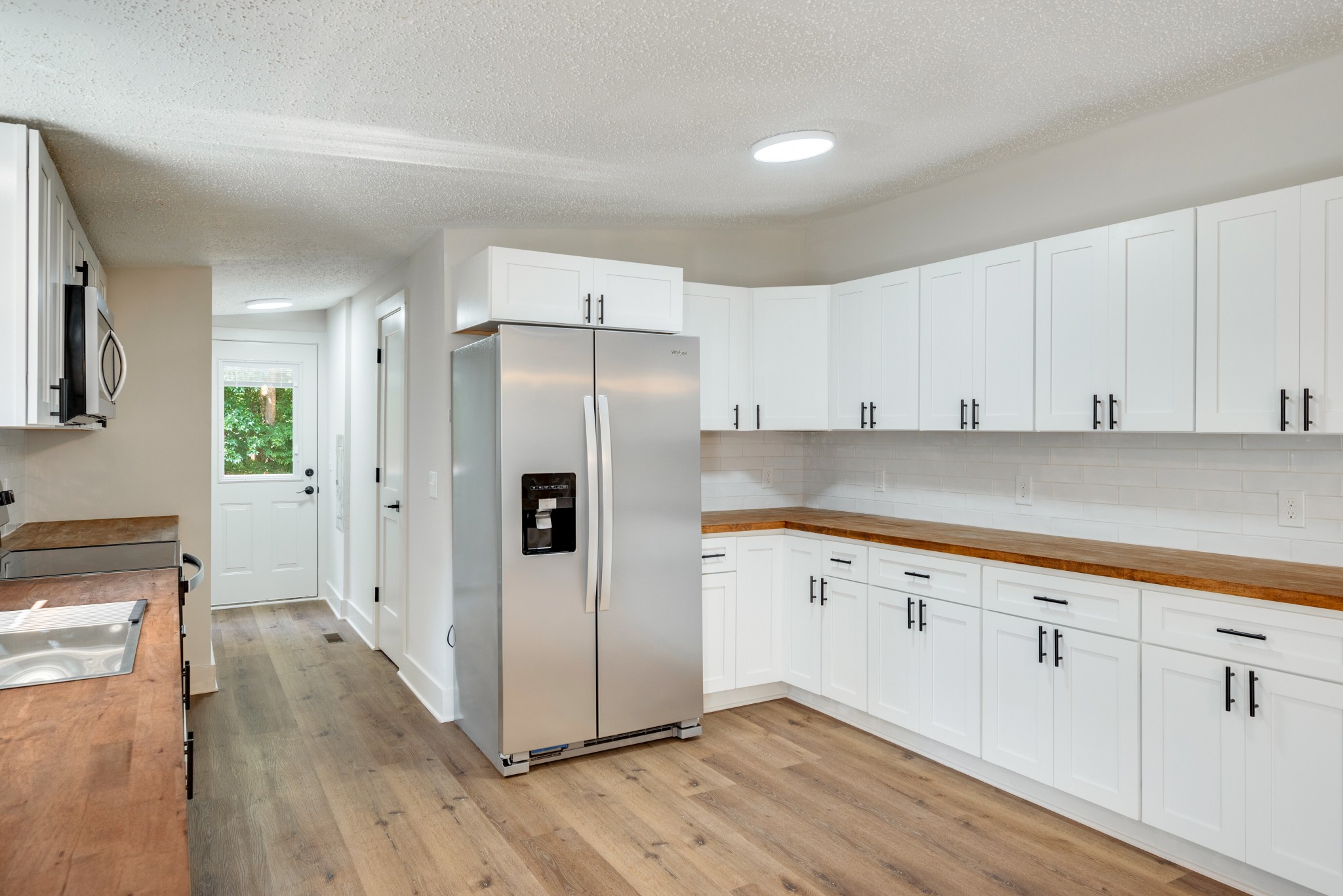 9064 New Chapel Road Springfield, TN 37172 - Photo 7 of 33 a kitchen with granite countertop white cabinets and refrigerator
