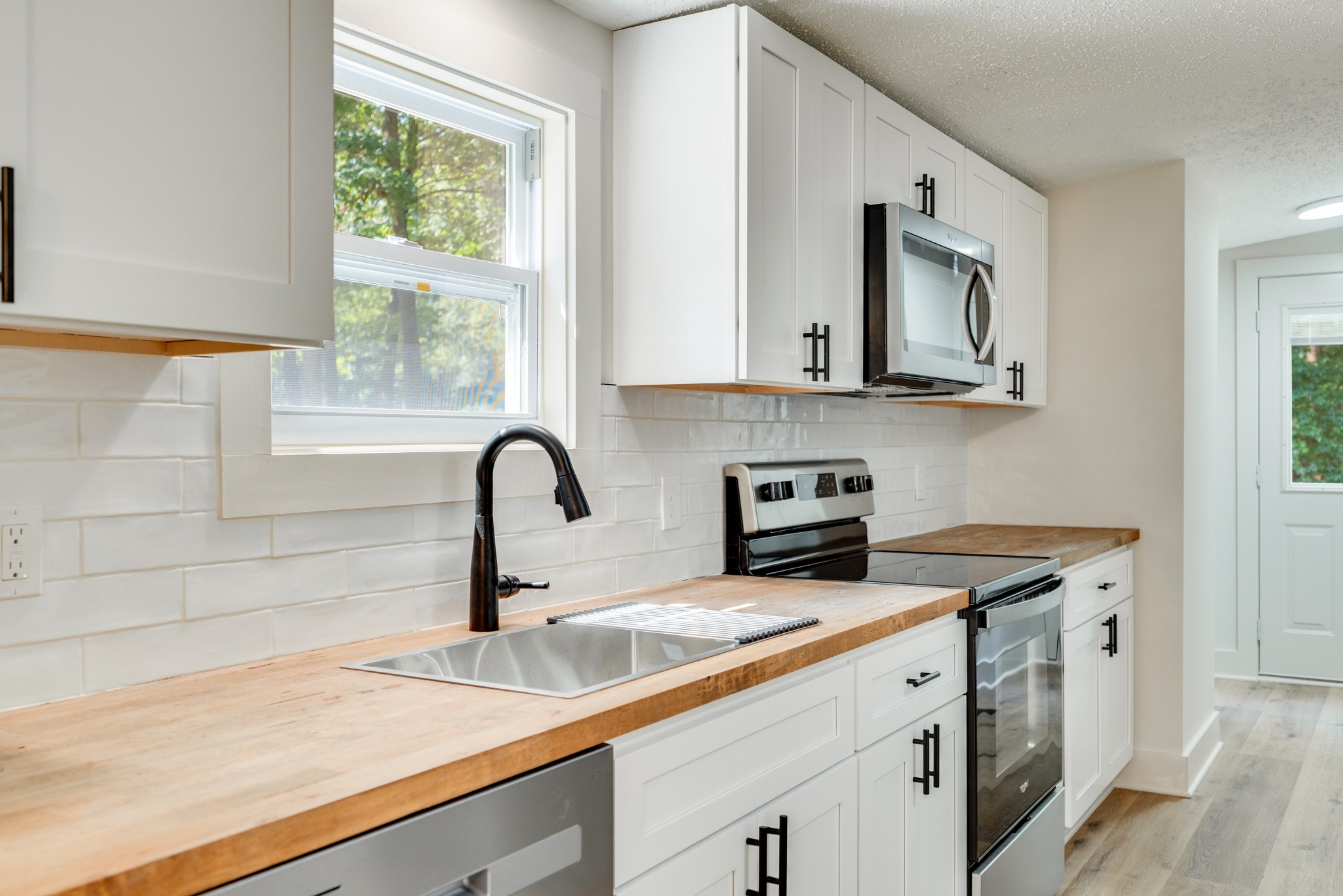 9064 New Chapel Road Springfield, TN 37172 - Photo 8 of 33 a view of a kitchen with sink a stove and furniture