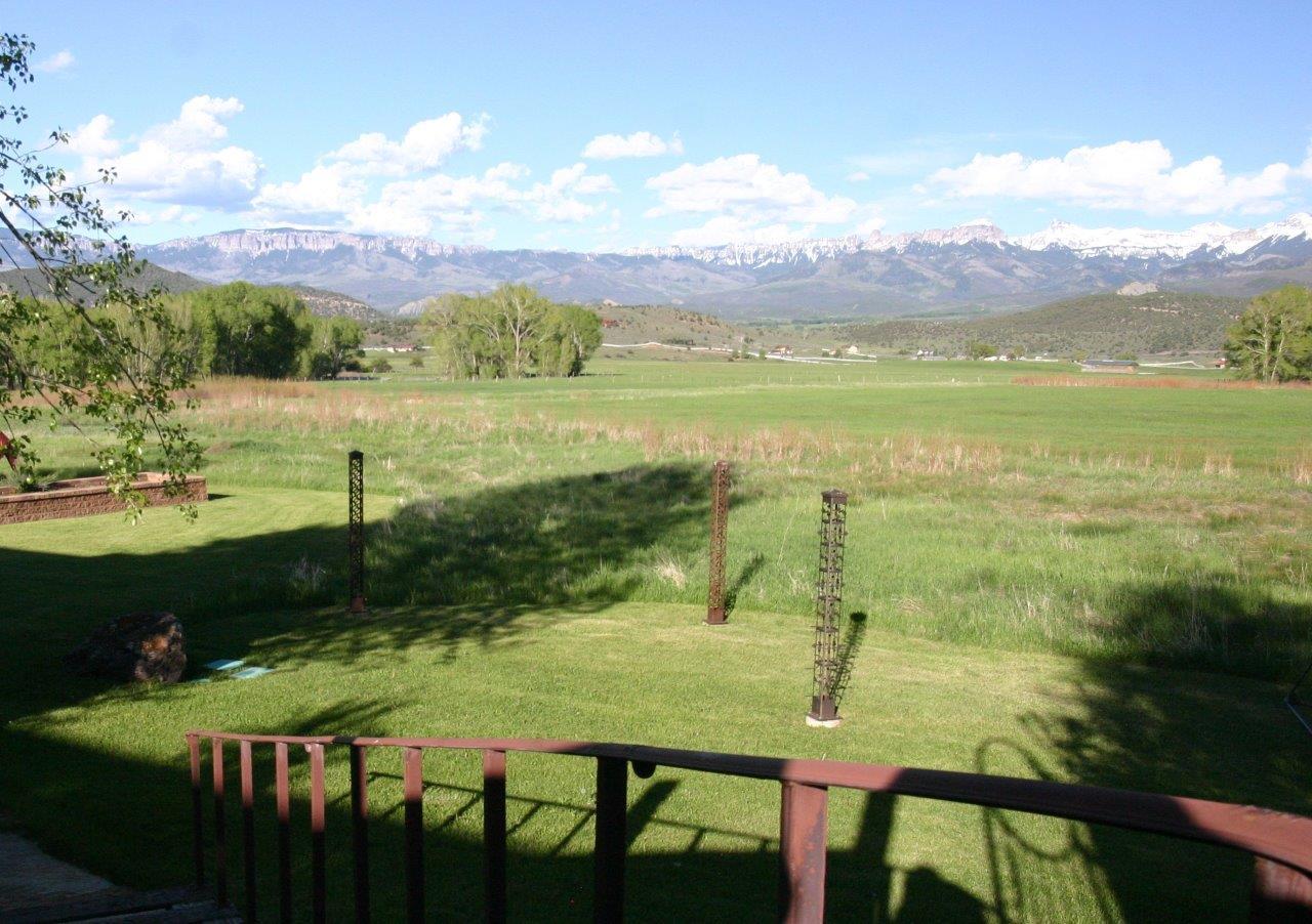 771 Cnty Road Ridgway, CO 81432 - Photo 47 of 68 Across the Lawn to the Meadows and Mtns