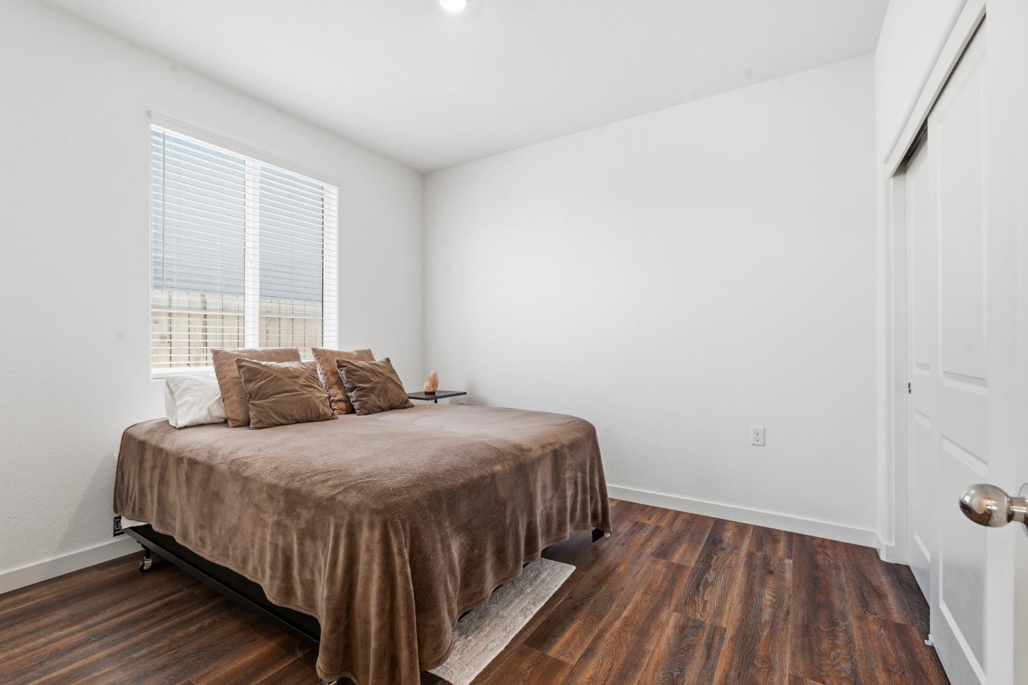 5713 Natalie Way Keyes, CA 95328 - Photo 20 of 30 a bedroom with a bed and wooden floor
