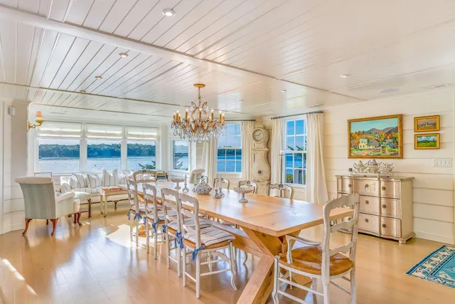 a view of a dining room with furniture chandelier and wooden floor