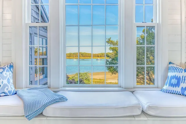 a bedroom with a large bed and a large window