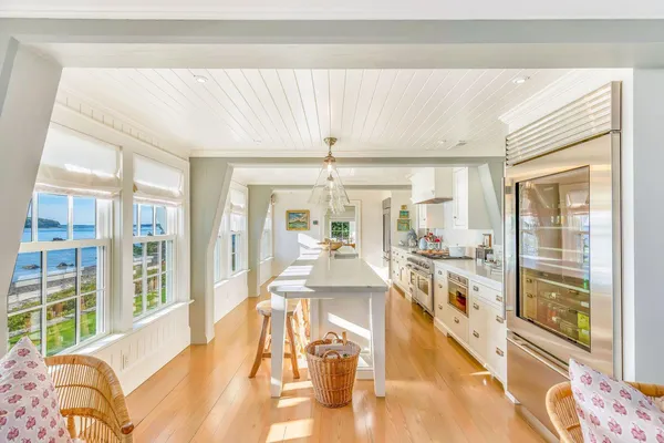 a large white kitchen with a large window
