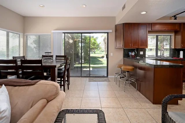 a living room filled with furniture and a large window