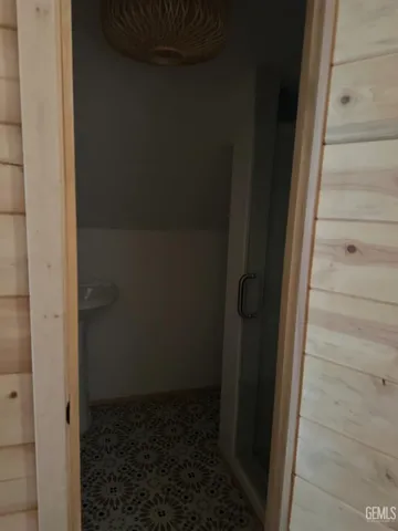a view of a balcony with wooden floor and iron fence