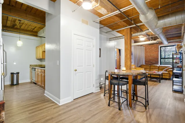 a view of a dining room with furniture and wooden floor