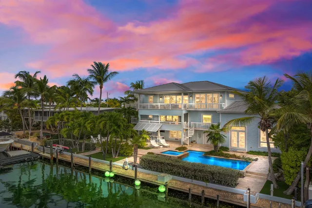 a view of a house with swimming pool and sitting area