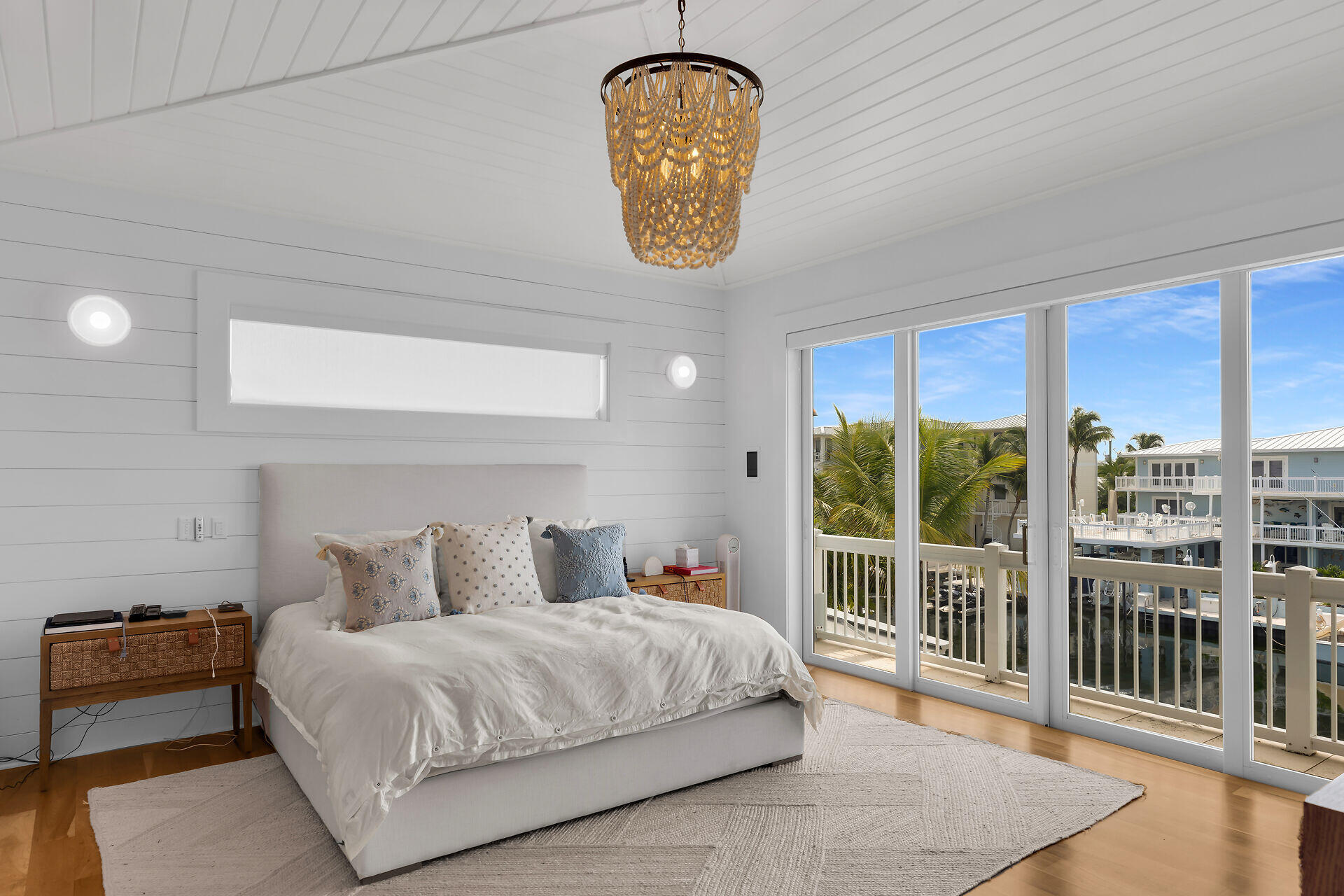 133 Severino Drive Islamorada, FL 33036 - Photo 14 of 27 a bedroom with a bed a mirror and a large window