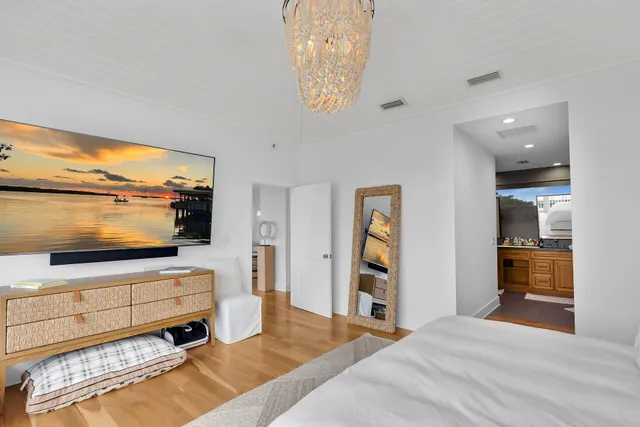 a bedroom with furniture and a flat screen tv