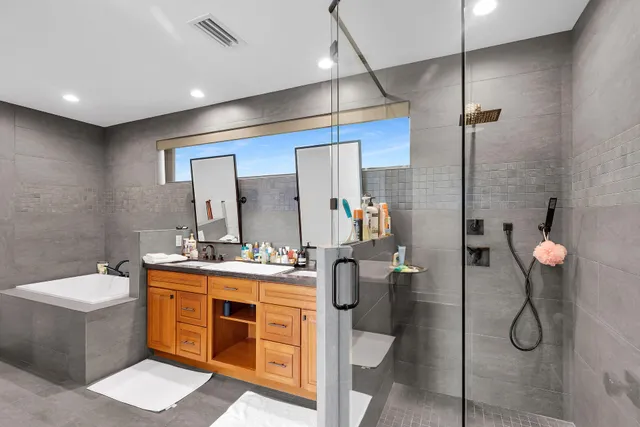 a bathroom with a double vanity sink mirror and toilet