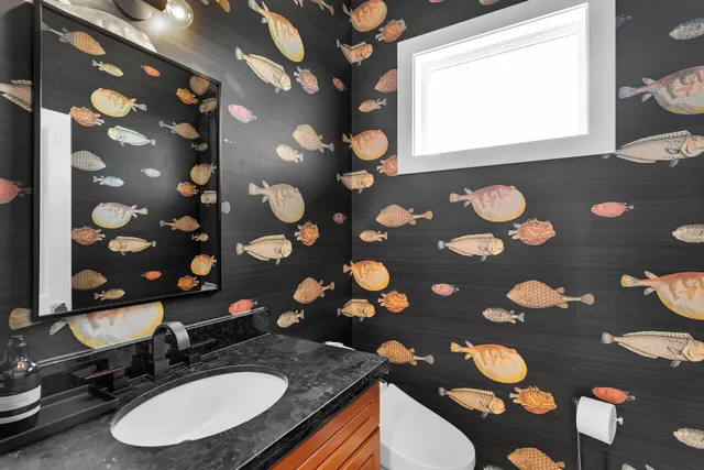 a bathroom with a sink toilet and a mirror