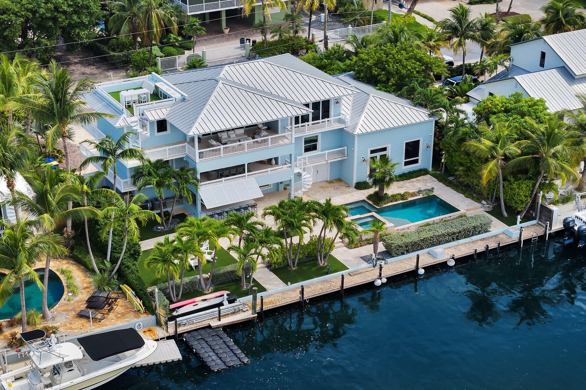 133 Severino Drive Islamorada, FL 33036 - Photo 2 of 27 a view of a chairs and table in the backyard