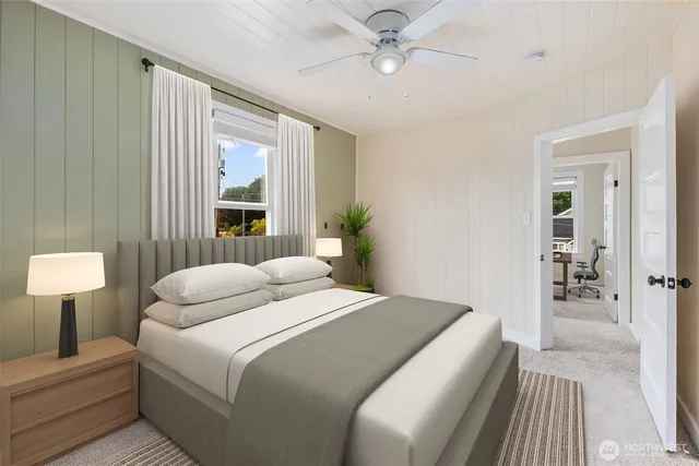 a bedroom with a large bed and a chandelier