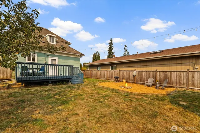 a backyard of a house with yard and trampoline