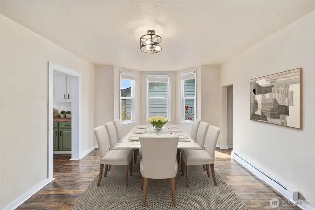 a dining room with furniture a potted plant and a chandelier