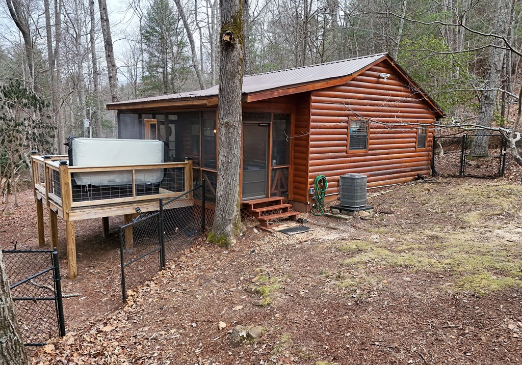 266 Mabry Lane Morganton, GA 30560 - Photo 6 of 37 a backyard of a house with wooden fence and roof