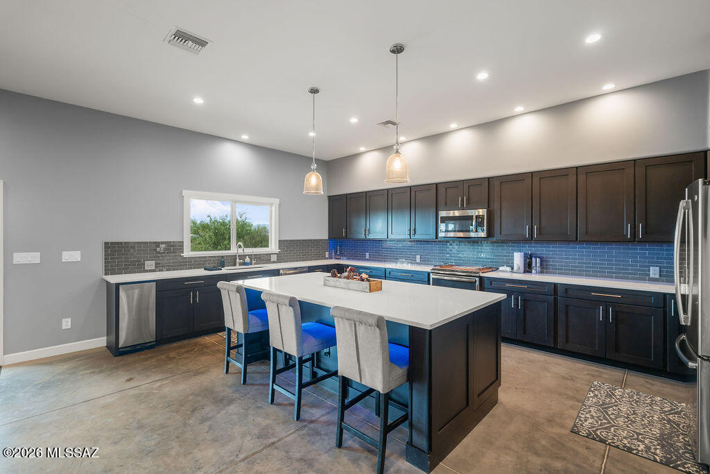 16276 East Empire View Road Vail, AZ 85641 - Photo 16 of 51 a large kitchen with a table and chairs