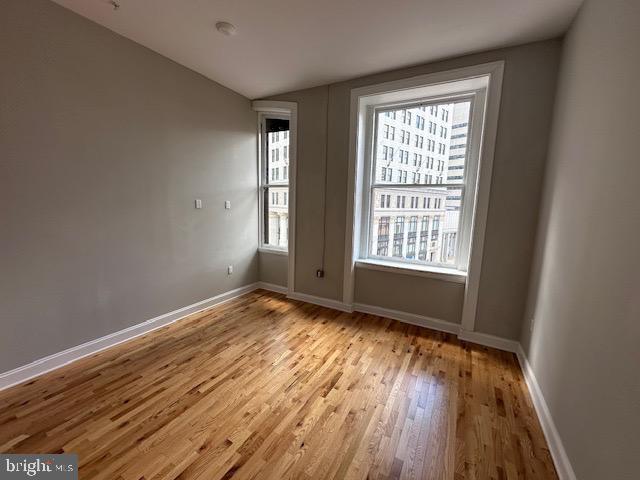100 West Lexington Street, Unit 305 Baltimore, MD 21201 - Photo 27 of 38 a view of an empty room with wooden floor and a window