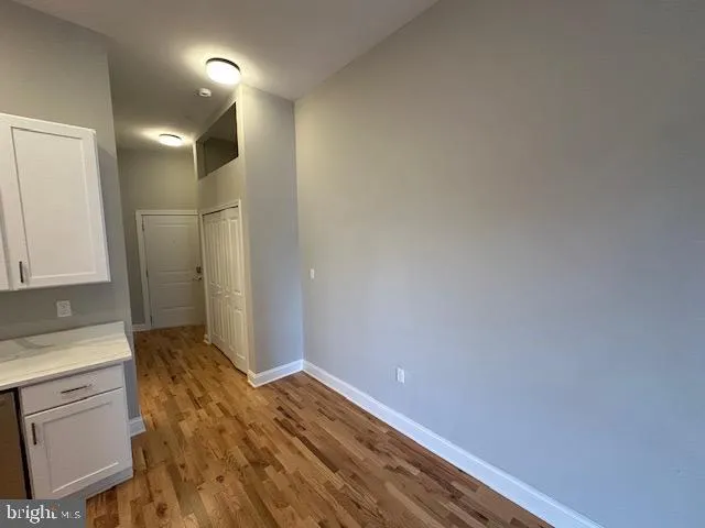 a view of hallway with wooden floor