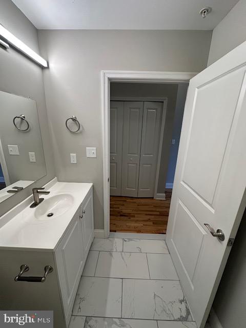 100 West Lexington Street, Unit 305 Baltimore, MD 21201 - Photo 32 of 38 a bathroom with a sink a toilet and vanity