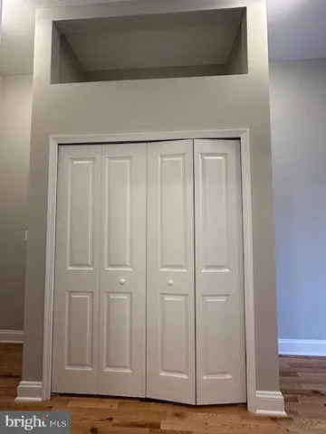 a bedroom with a bed and a mirror