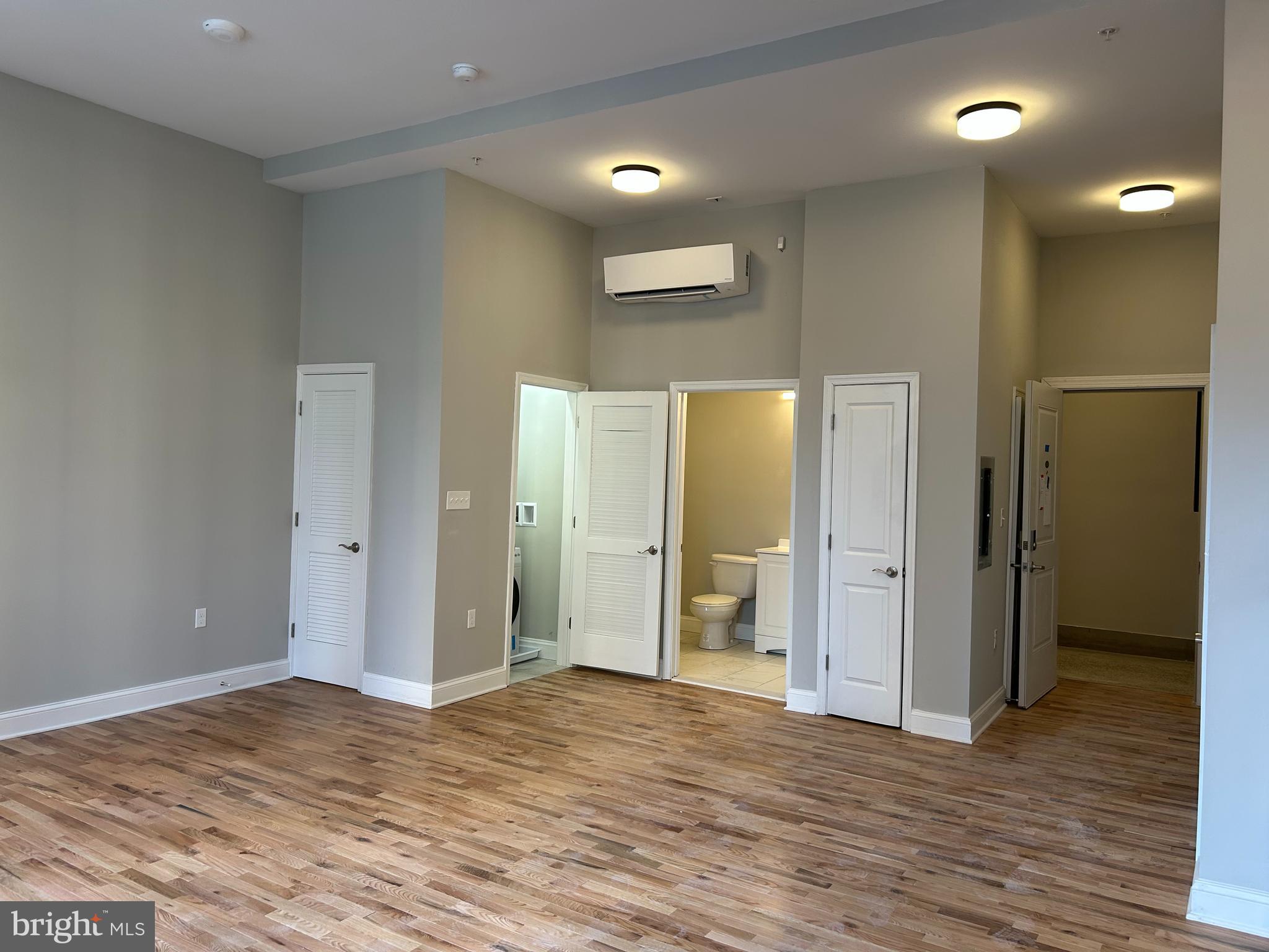100 West Lexington Street, Unit 305 Baltimore, MD 21201 - Photo 9 of 38 a view of an empty room with wooden floor and a bathroom