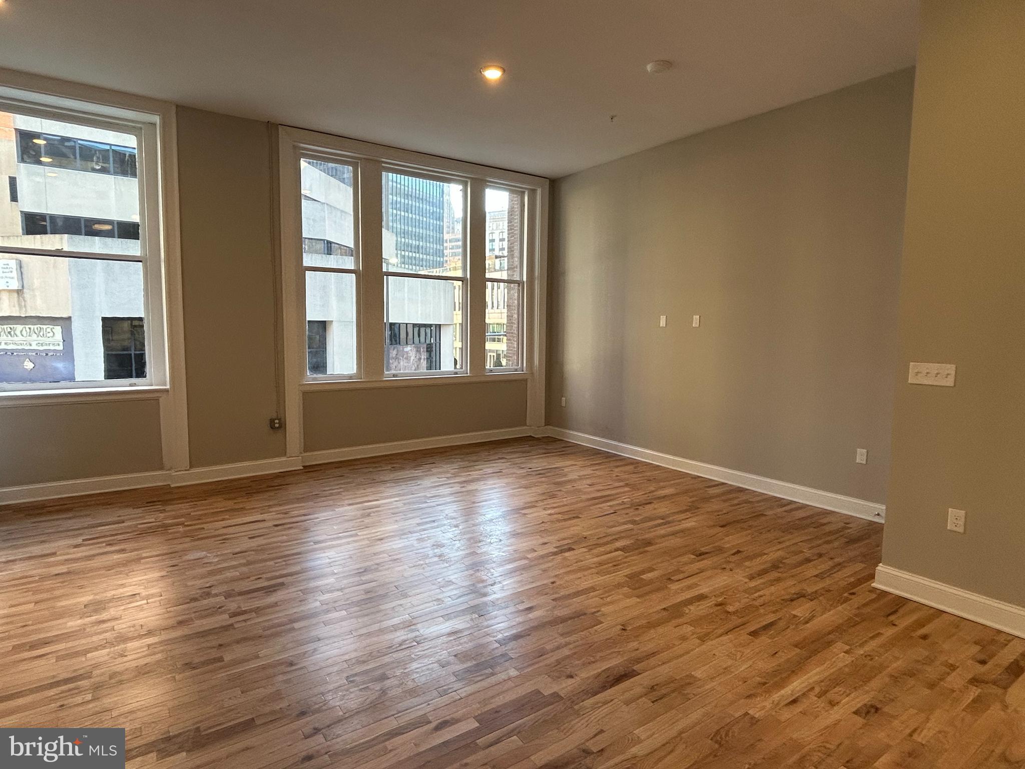 100 West Lexington Street, Unit 305 Baltimore, MD 21201 - Photo 10 of 38 a view of an empty room with wooden floor and a window