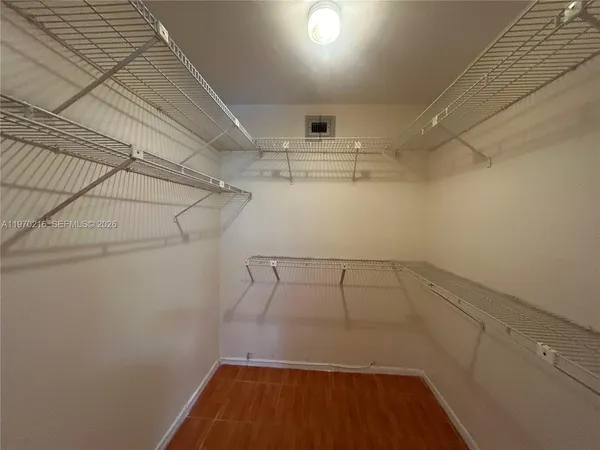 a bathroom with a bathtub shower sink vanity mirror and toilet