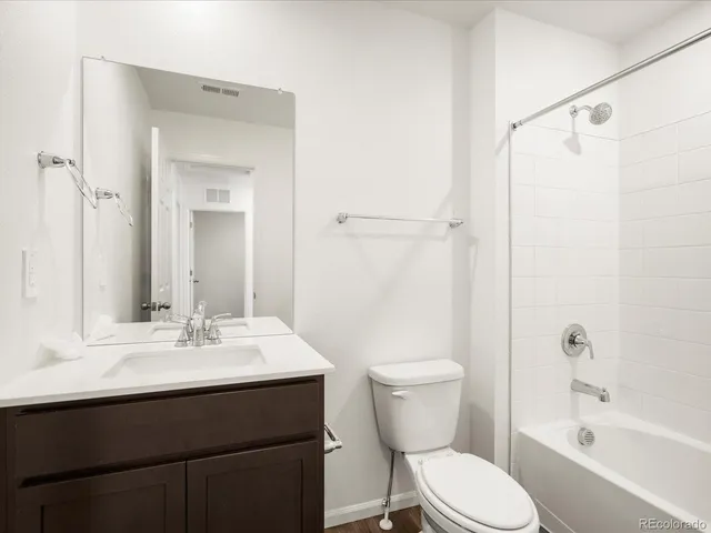 a bathroom with a sink toilet a mirror and shower