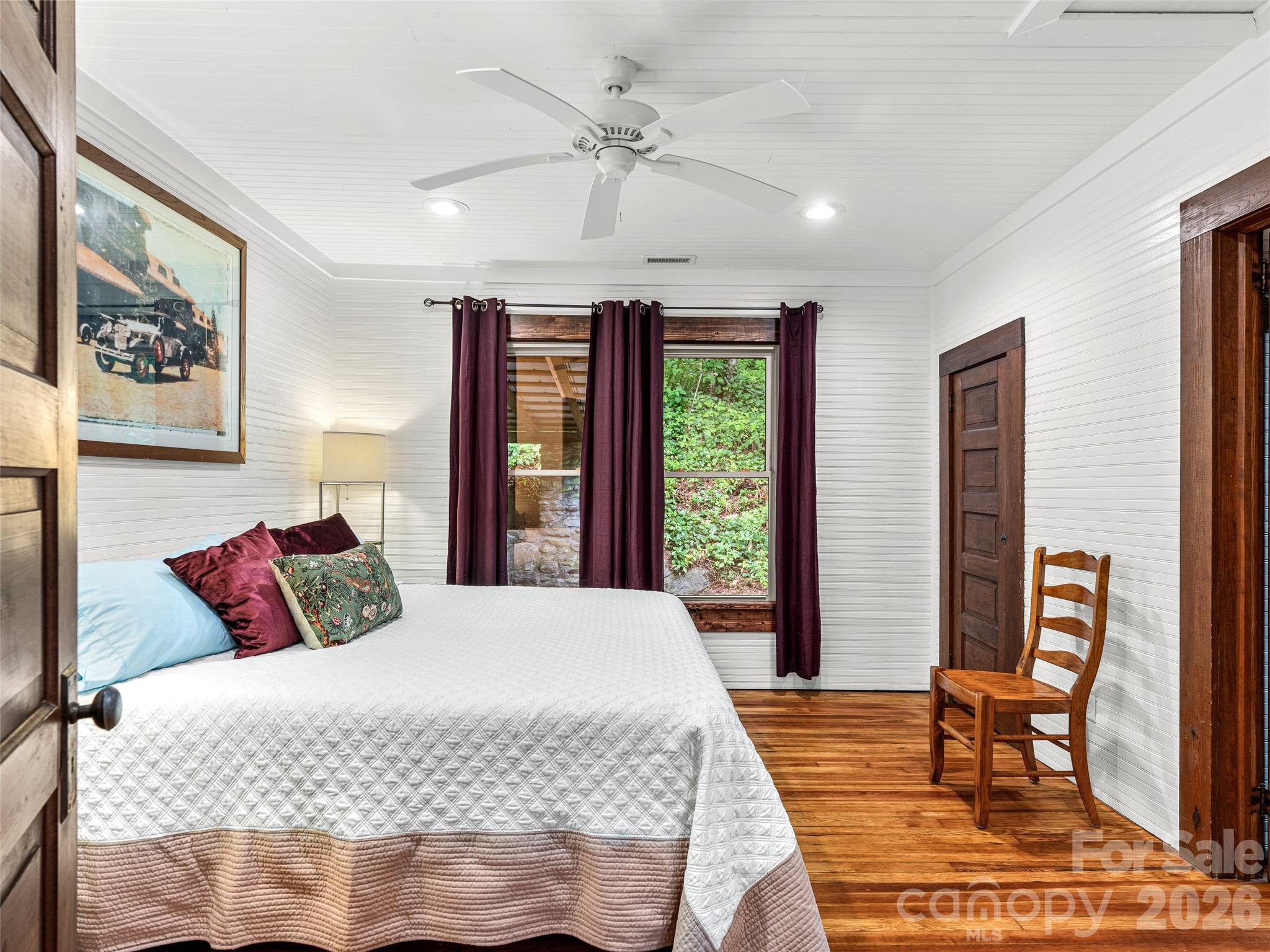 206 Chestnut Hill Road Gerton, NC 28735 - Photo 25 of 48 a bedroom with a large bed and a large window