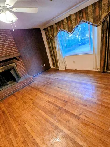 a view of a room with wooden floor and door