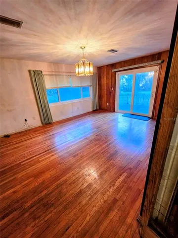 a view of a room with wooden floor