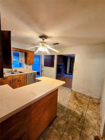 a large kitchen with kitchen island a sink stainless steel appliances and cabinets
