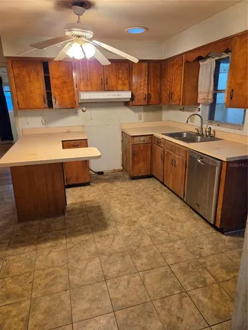 a kitchen with a sink cabinets and window