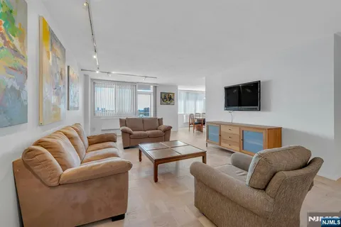 a living room with furniture and a flat screen tv