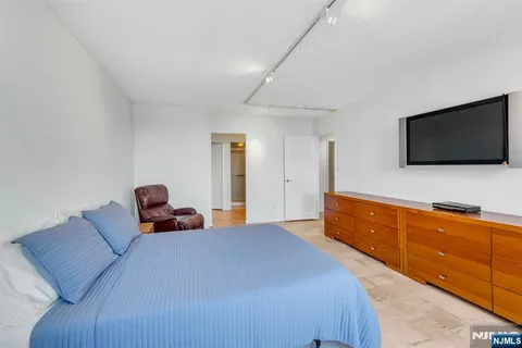a bedroom with a bed and a flat screen tv