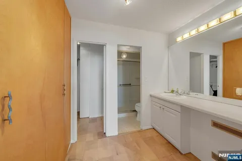 a spacious bathroom with a granite countertop sink mirror and toilet
